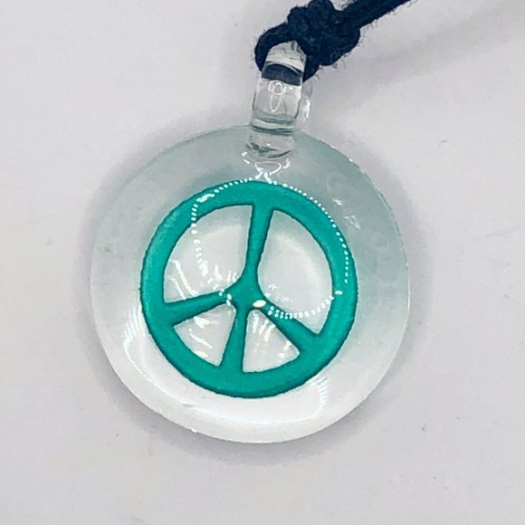 Peace sign etched in clear glass pendant on black cord